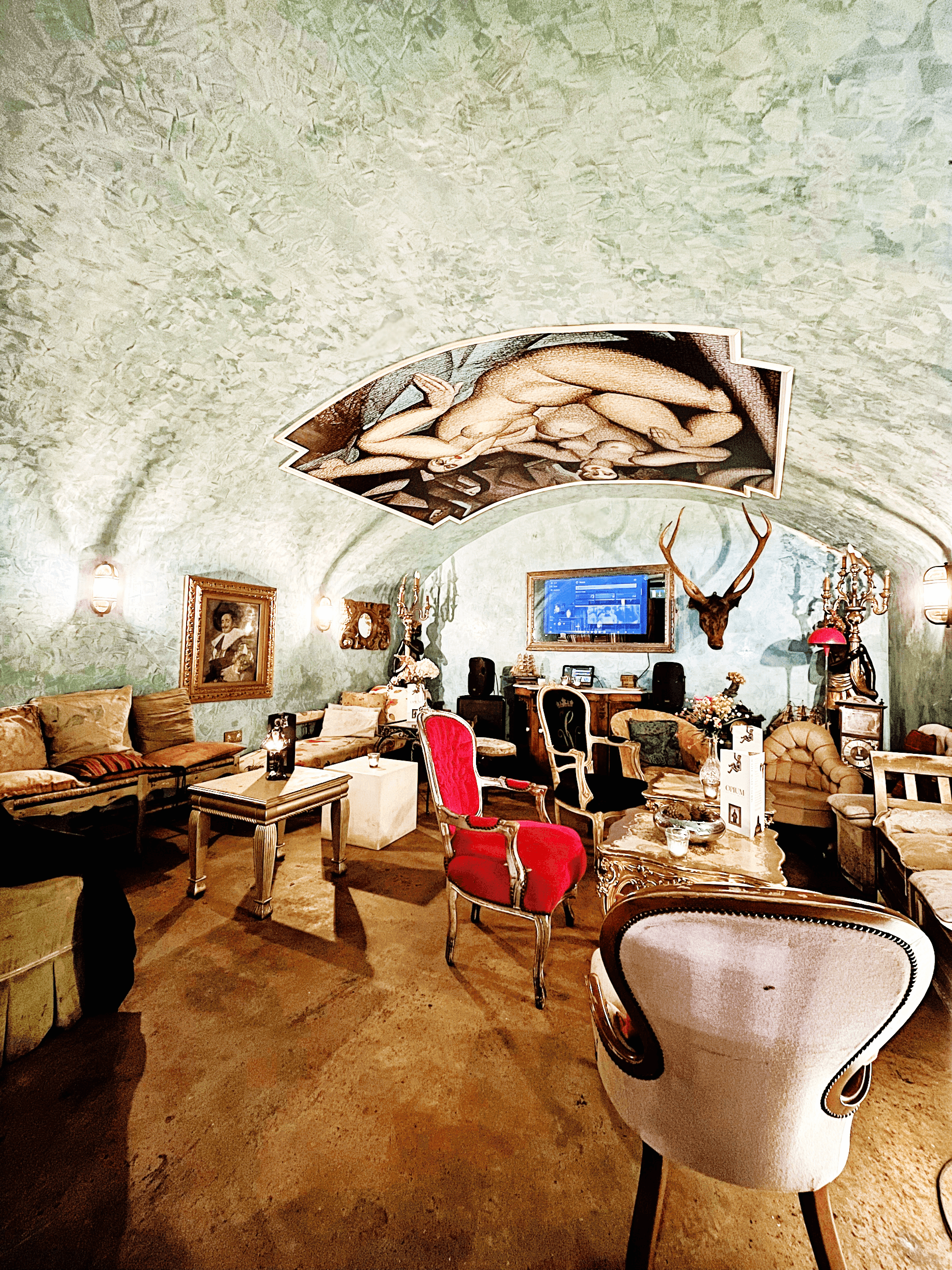 A jewel-toned cocktail set against the vault's darkness.