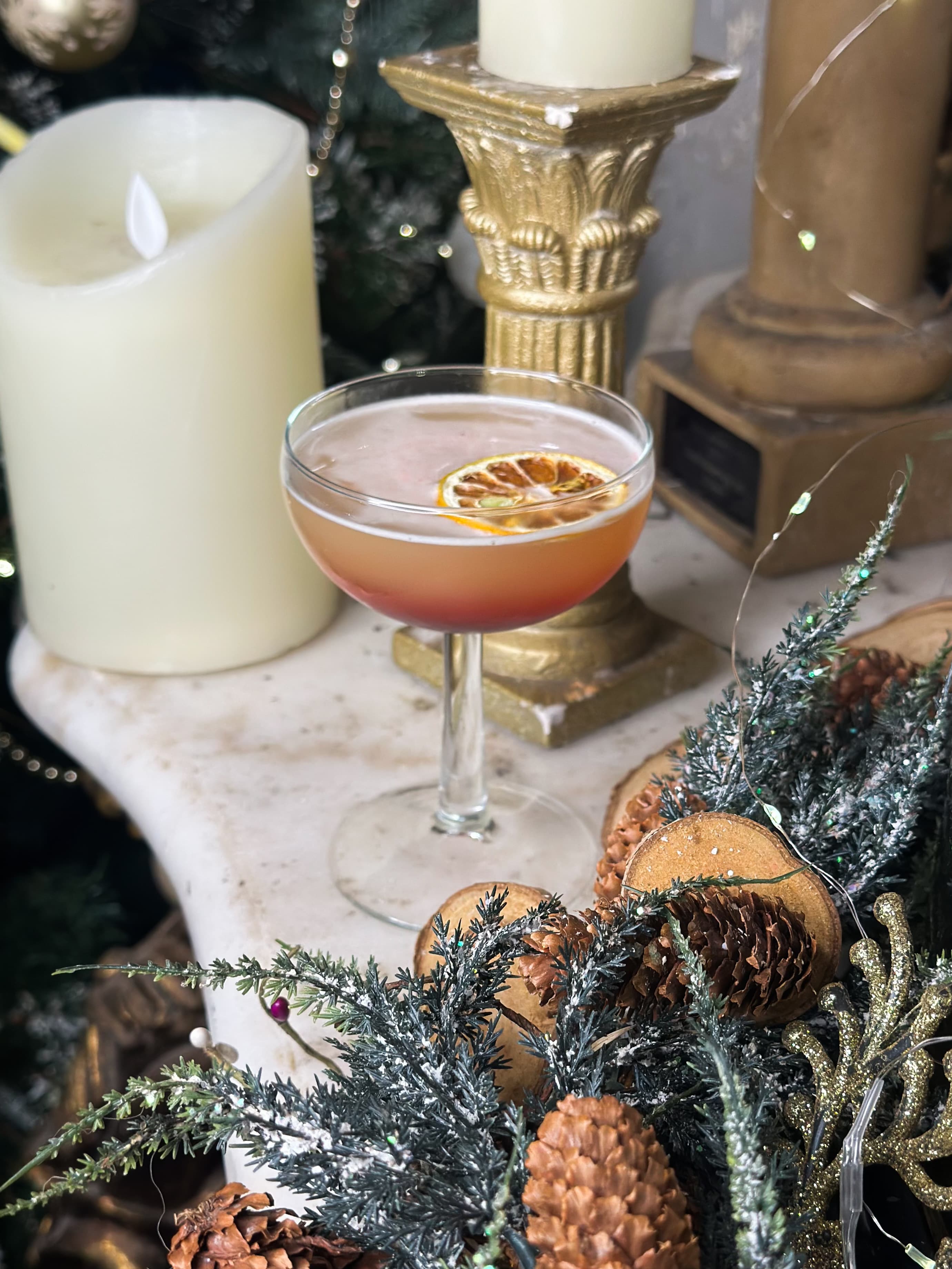 A coupe cocktail styled with winter foliage and candlelight.